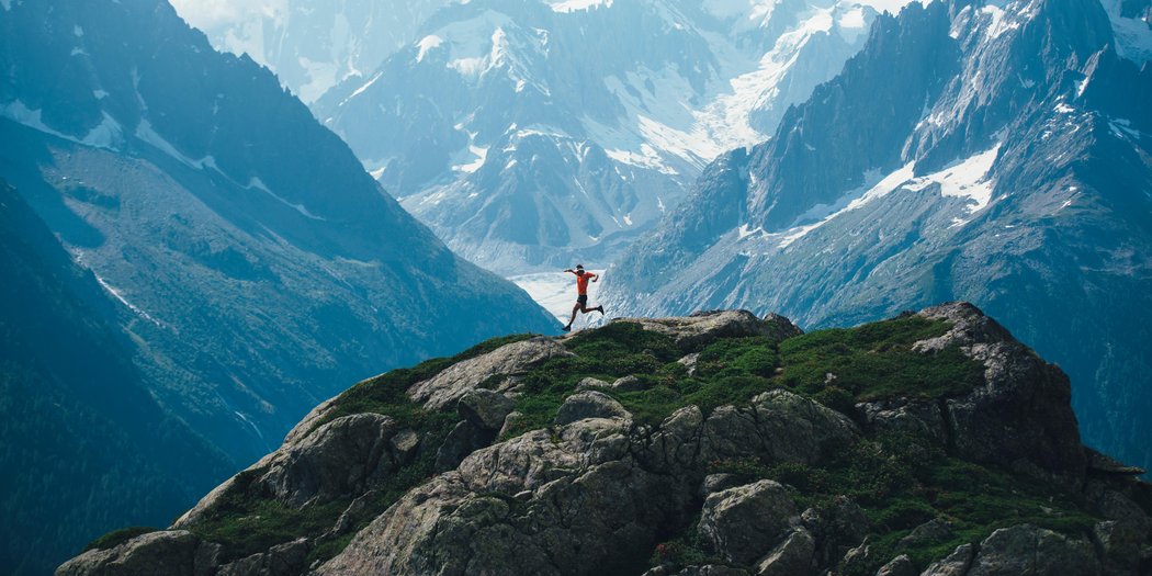 Runner moving strongly through long hilly terrain