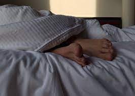 Woman experiencing interrupted sleep and overheating