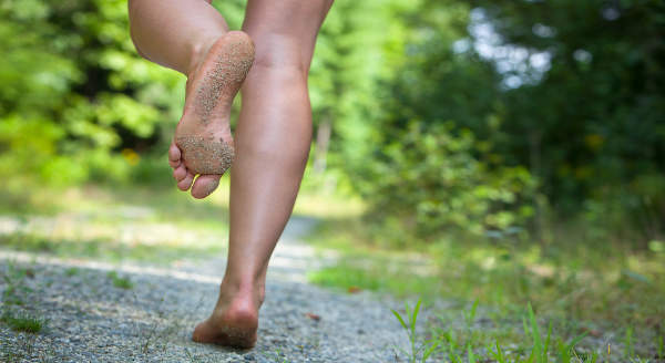 Barefoot runner on beach